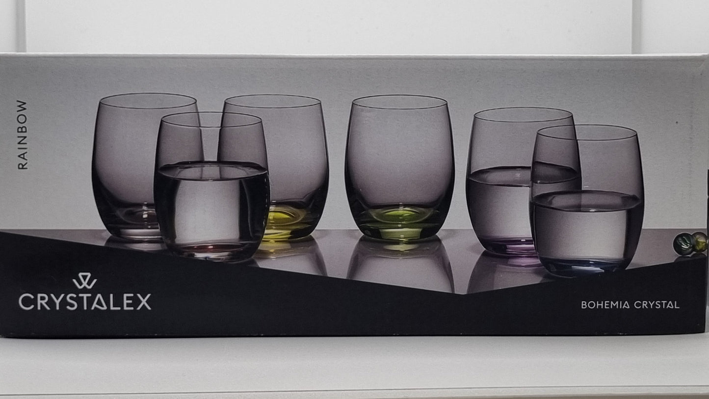 Box of Crystalex glasses with six colored glasses on a white surface.