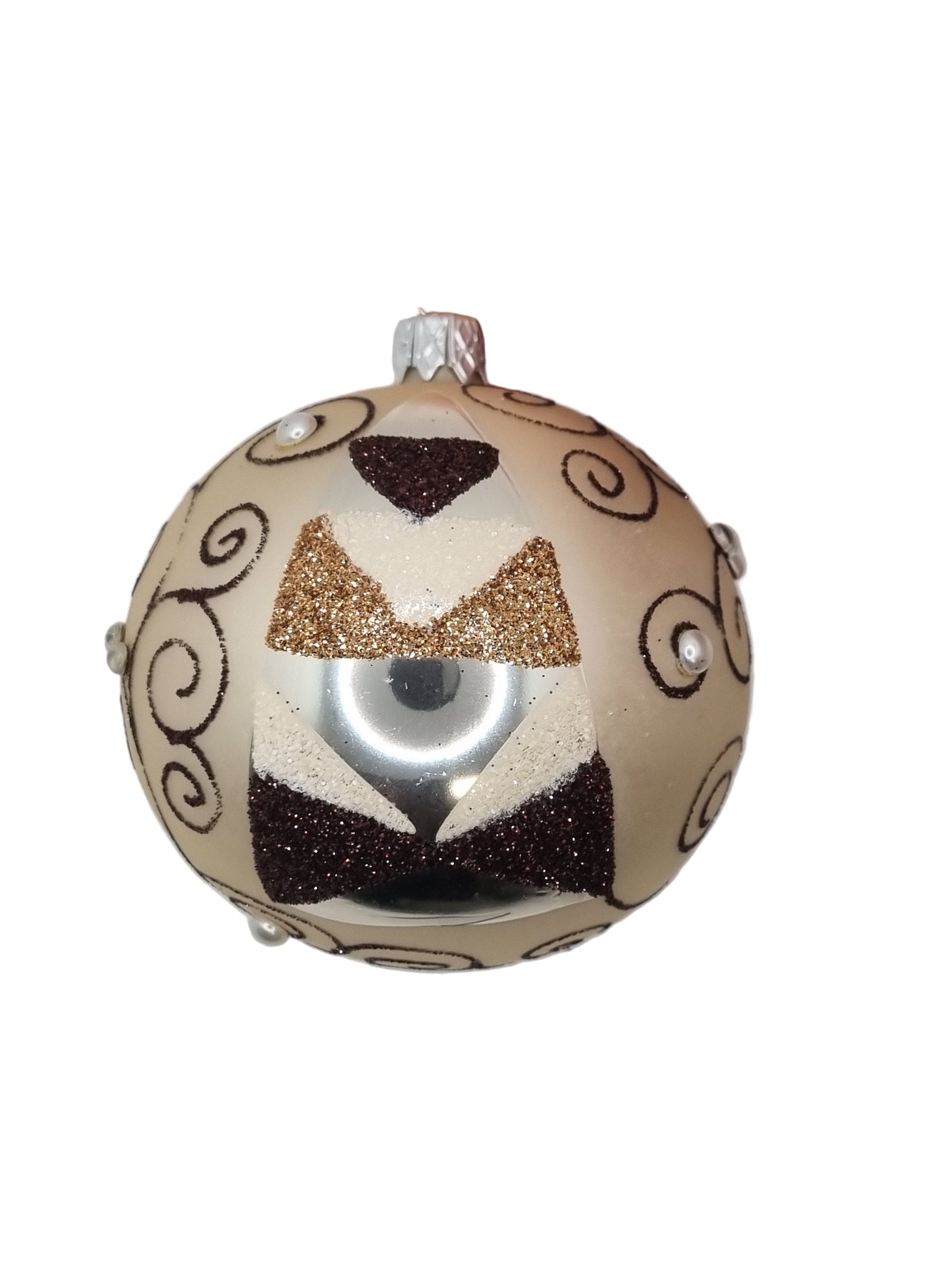 Decorative ornament with gold, black, and beige patterns on a white background