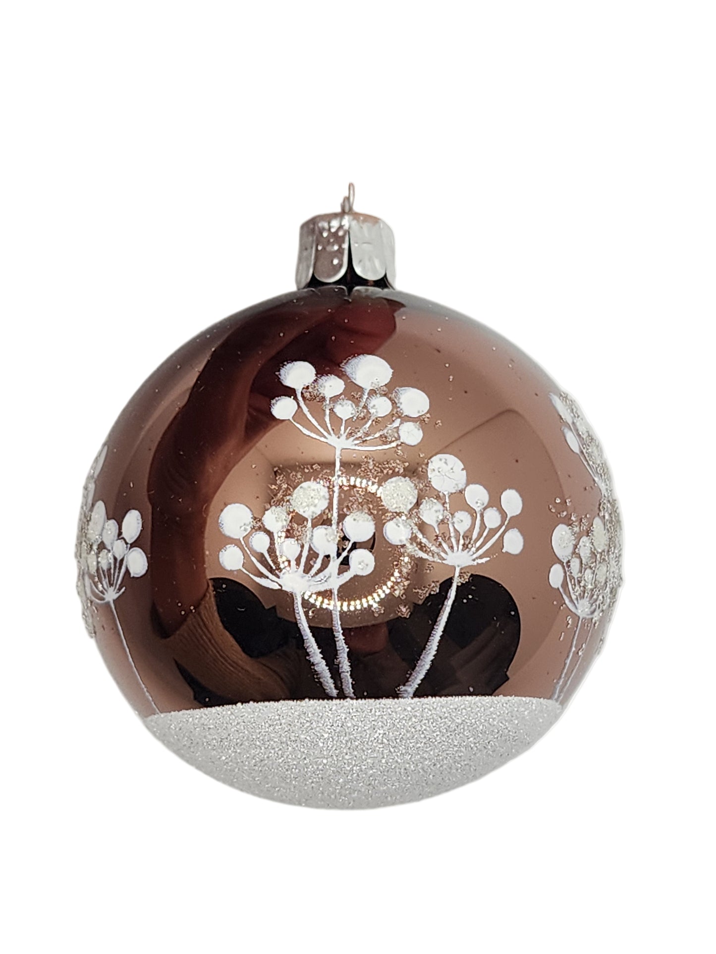 Decorative glass ornament with floral design held on a white background