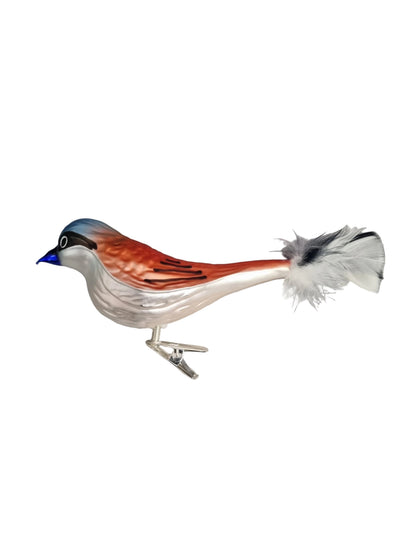 Glass sculpture of a bird on a white surface