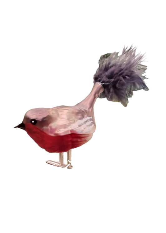 A decorative bird figurine with a red chest, pale pink and white head and back, and a dark gray feathered tail, standing on thin metallic legs against a plain white background.
