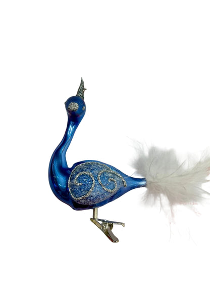 Blue glass bird ornament on a white background 