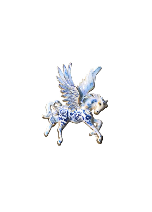 A small blue and white enamel winged horse brooch with floral detailing