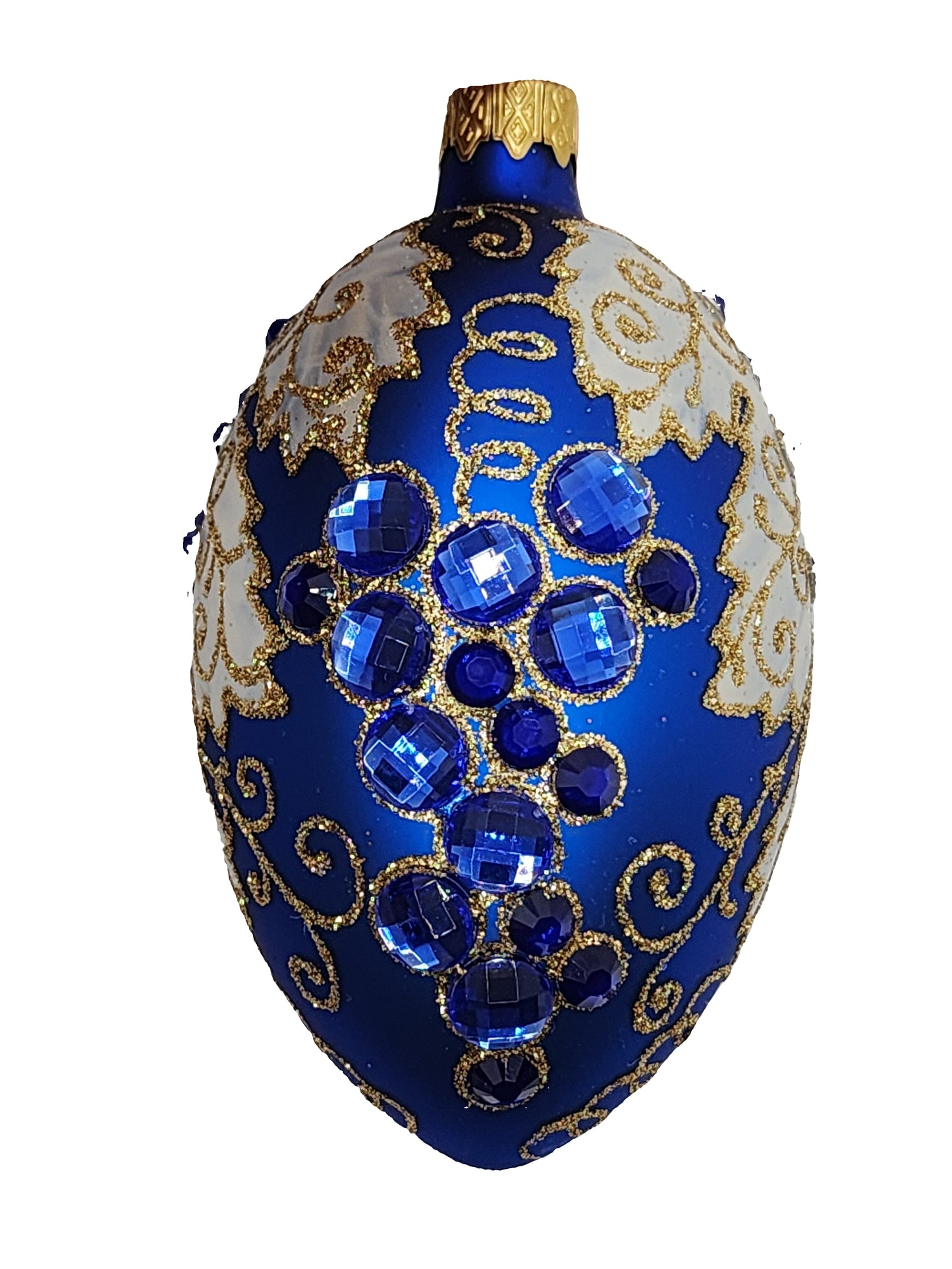 Decorative blue and gold ornament with blue gemstones on a white background