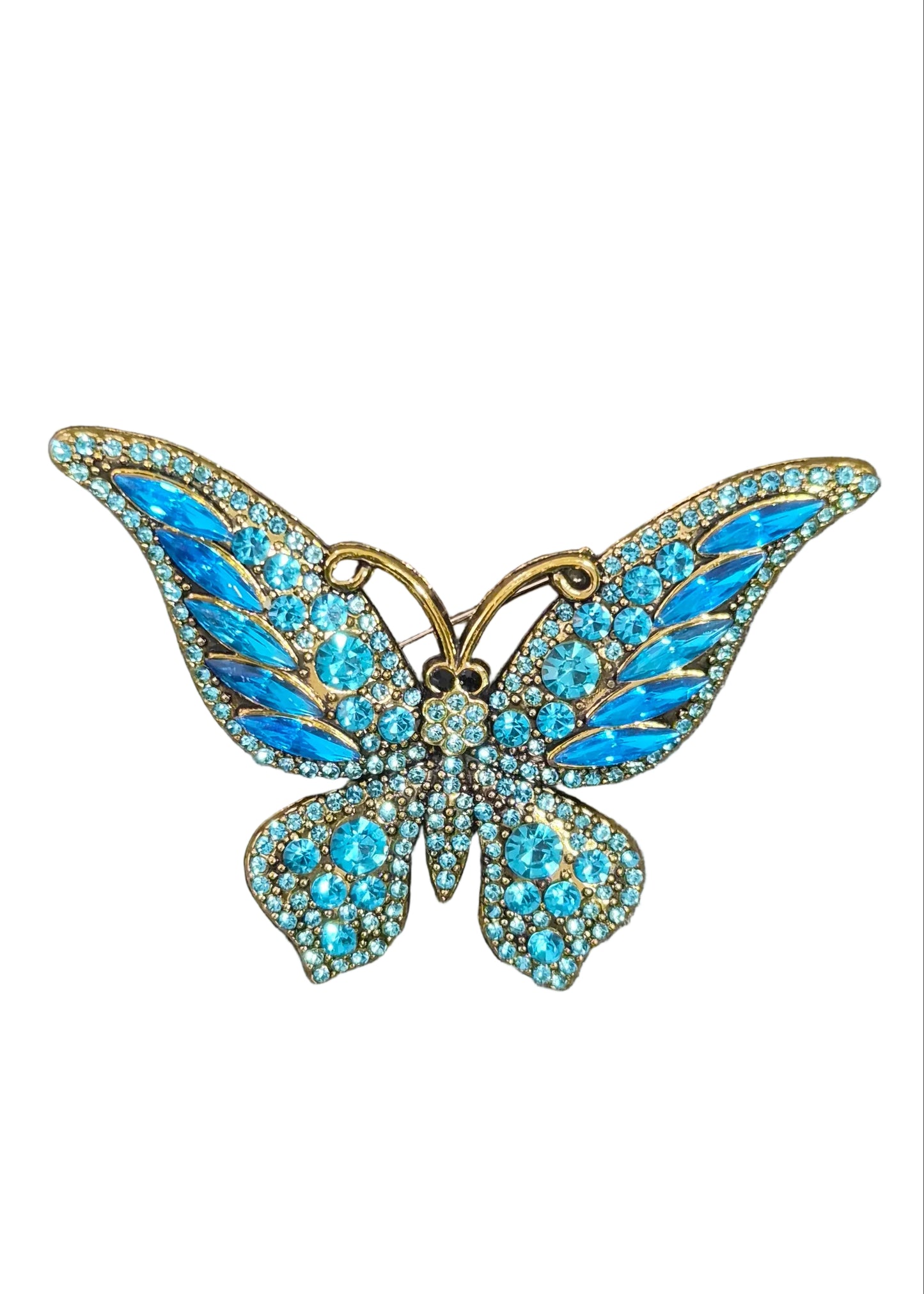 A butterfly-shaped brooch with bright blue rhinestone wings and gold-toned metal outlines