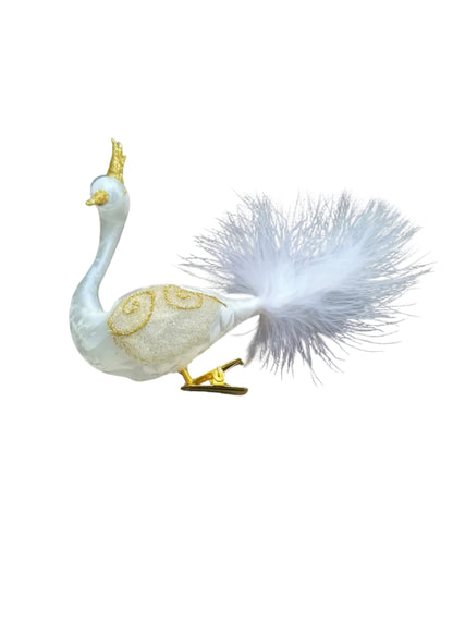 A decorative white peacock figurine with gold accents and a fluffy white tail.