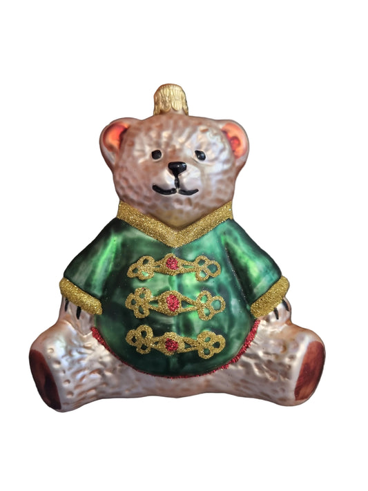 Decorative bear ornament with green jacket and gold accents 