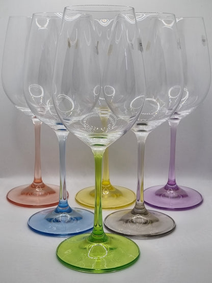 Set of colourful white wine glasses on a white background