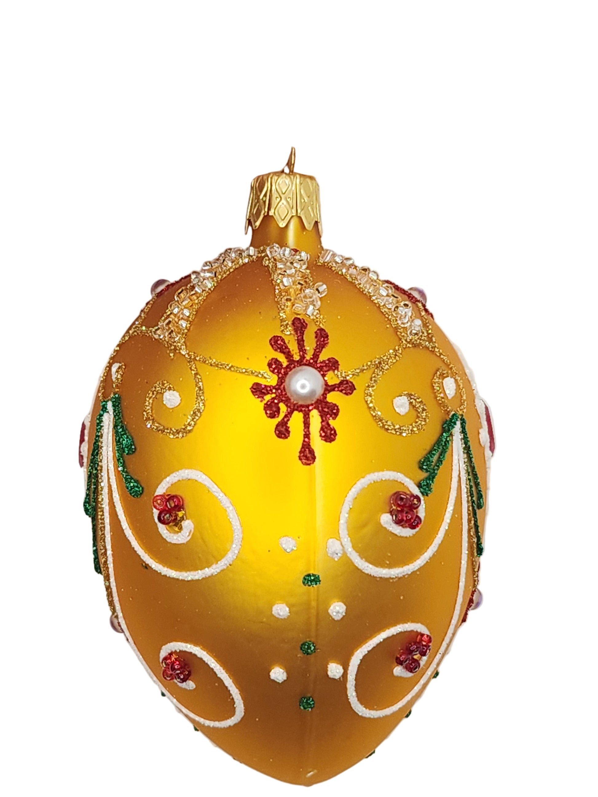 Decorative yellow egg with intricate designs on a white background