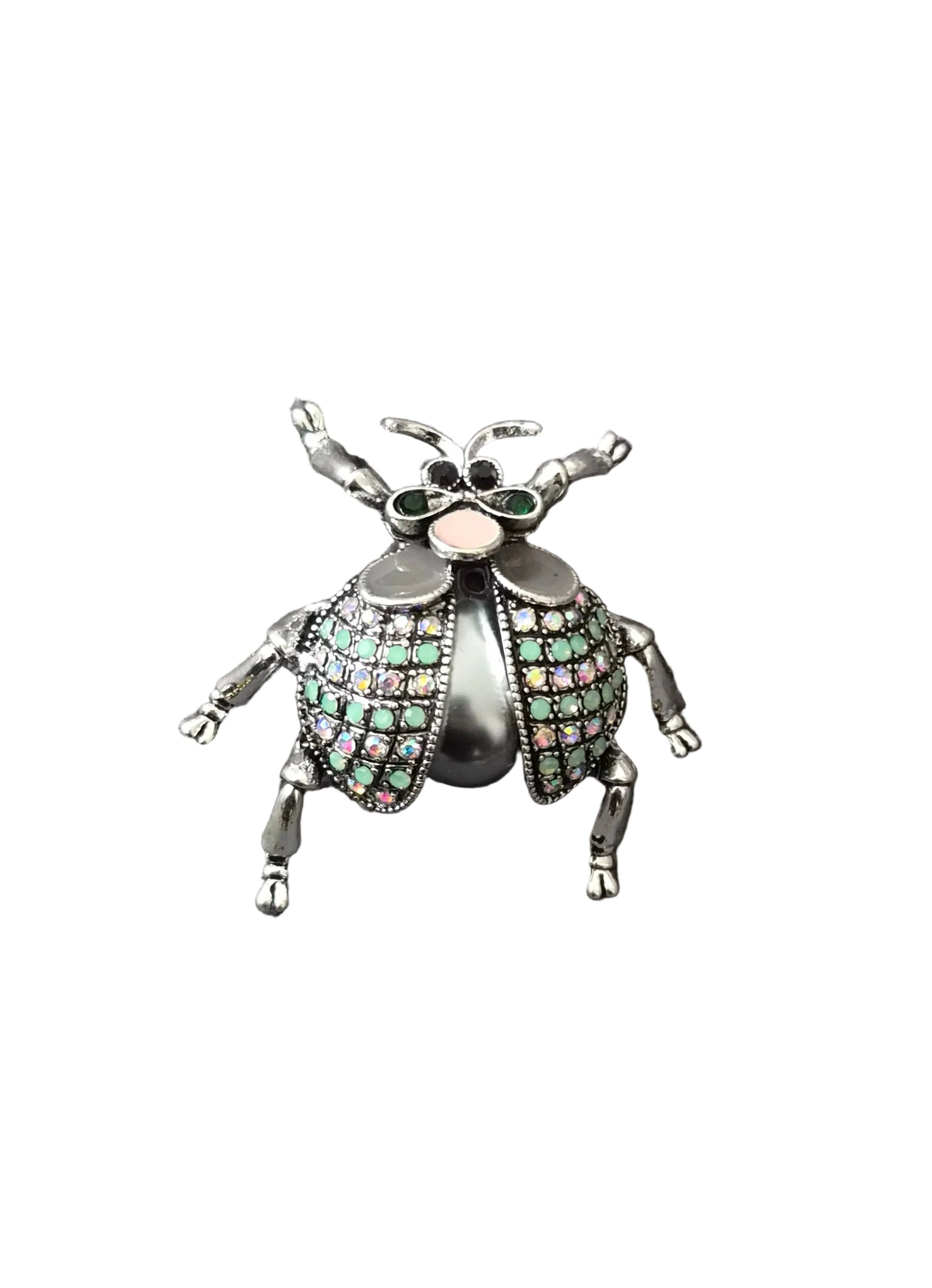 A metallic beetle-shaped brooch with green and pink rhinestone-embellished wings.