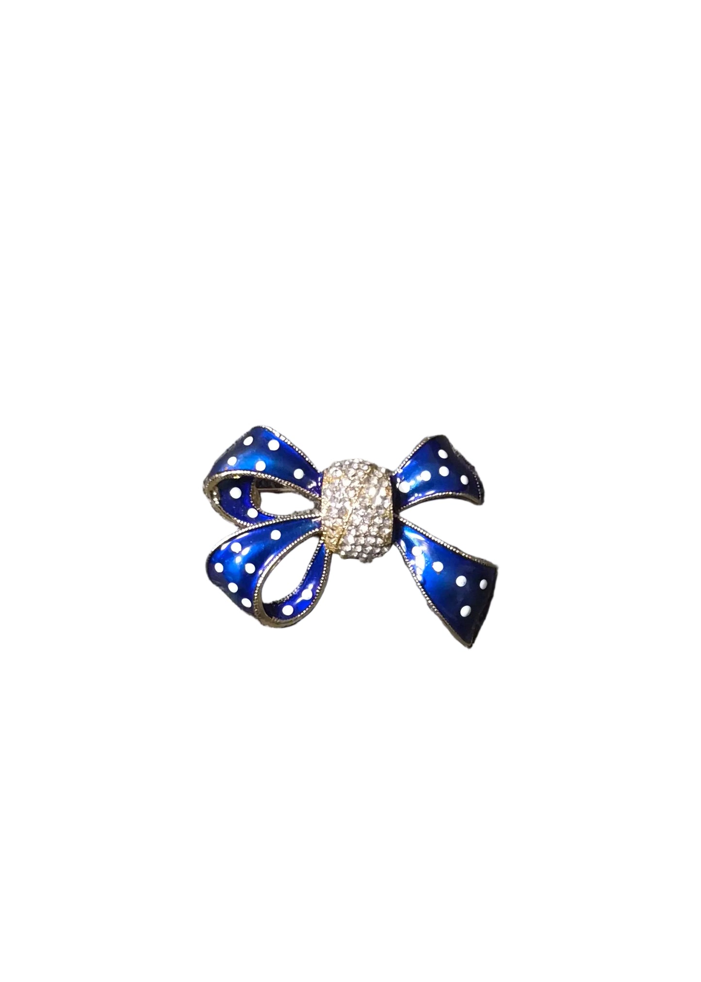 A small bow-shaped brooch with blue enamel, white polka dots, and a crystal-encrusted center