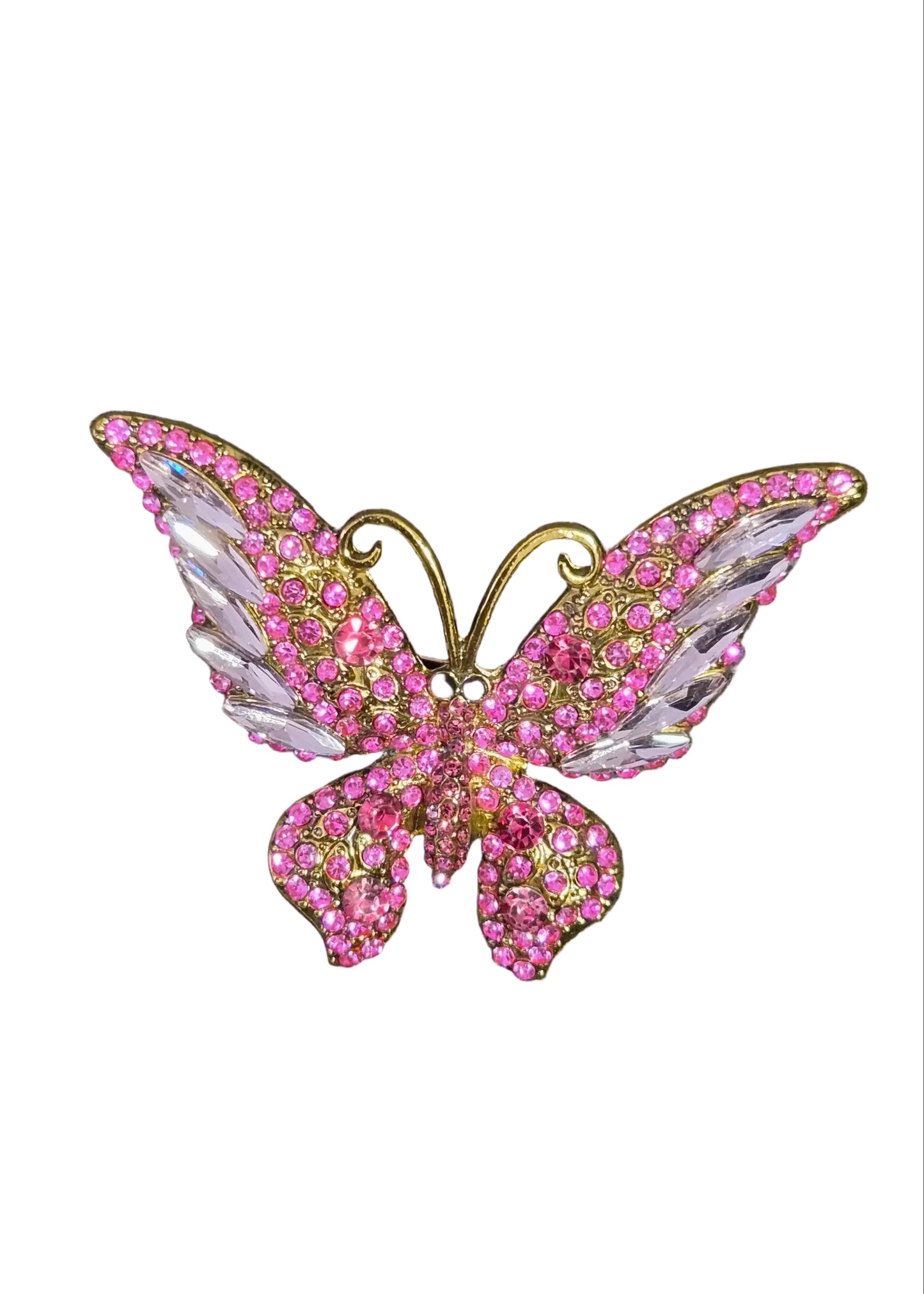 A butterfly-shaped brooch embellished with pink crystals and gold metal,.