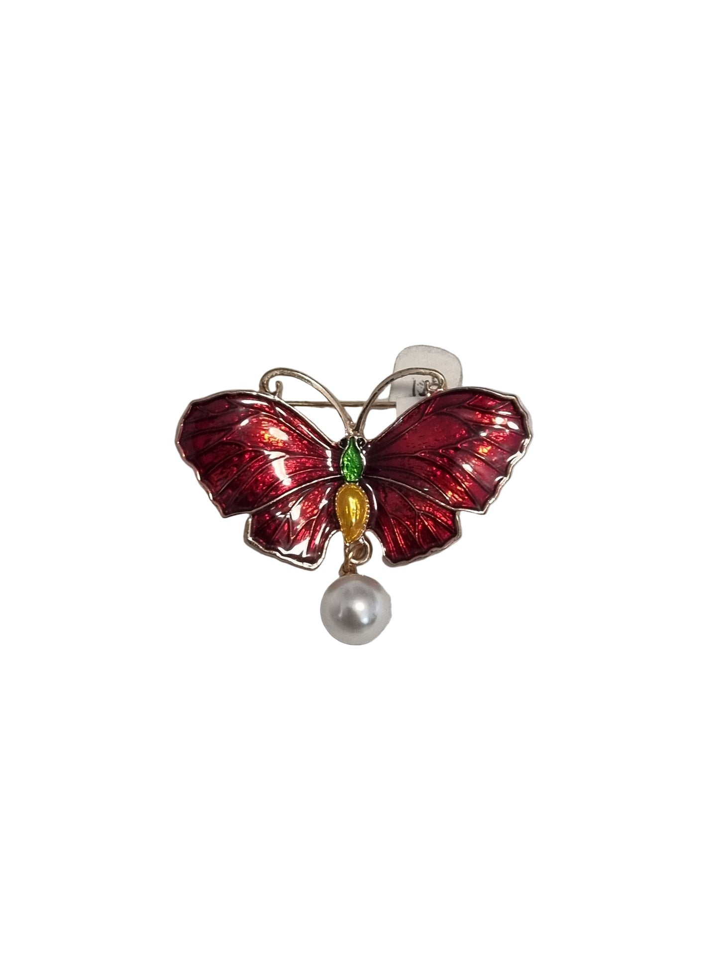 Red butterfly-shaped brooch with gemstones on a light gray background