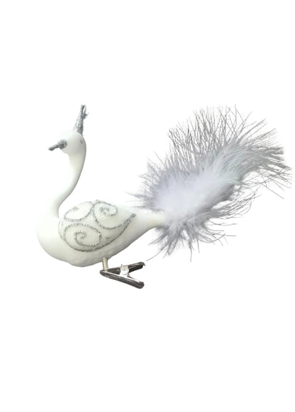 A white decorative swan ornament with silver swirl patterns and a fluffy white feather tail, attached to a silver clip.