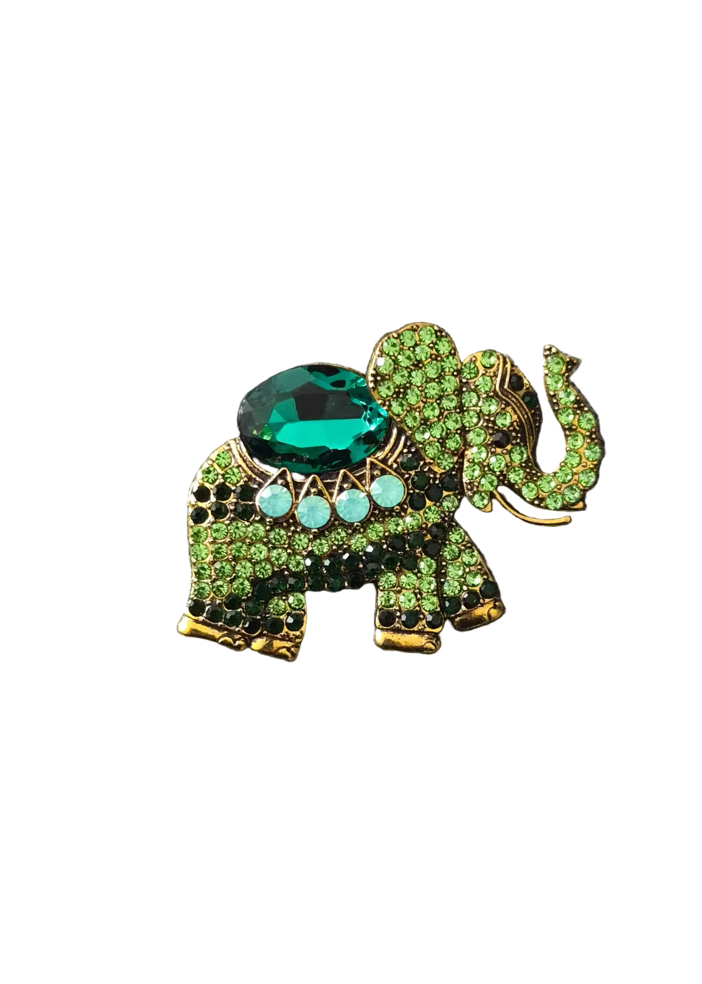 A gold-tone elephant-shaped brooch embellished with green rhinestones, a large green faceted gemstone on the back, and three light blue stones.