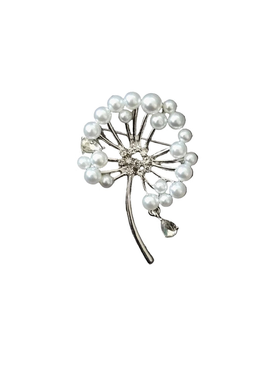 A silver-toned dandelion brooch decorated with white faux pearls and a clear rhinestone center.