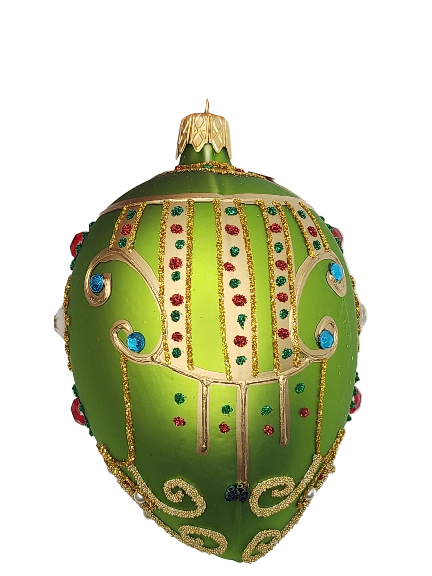 Decorative green egg with gold and gemstone details against a white background