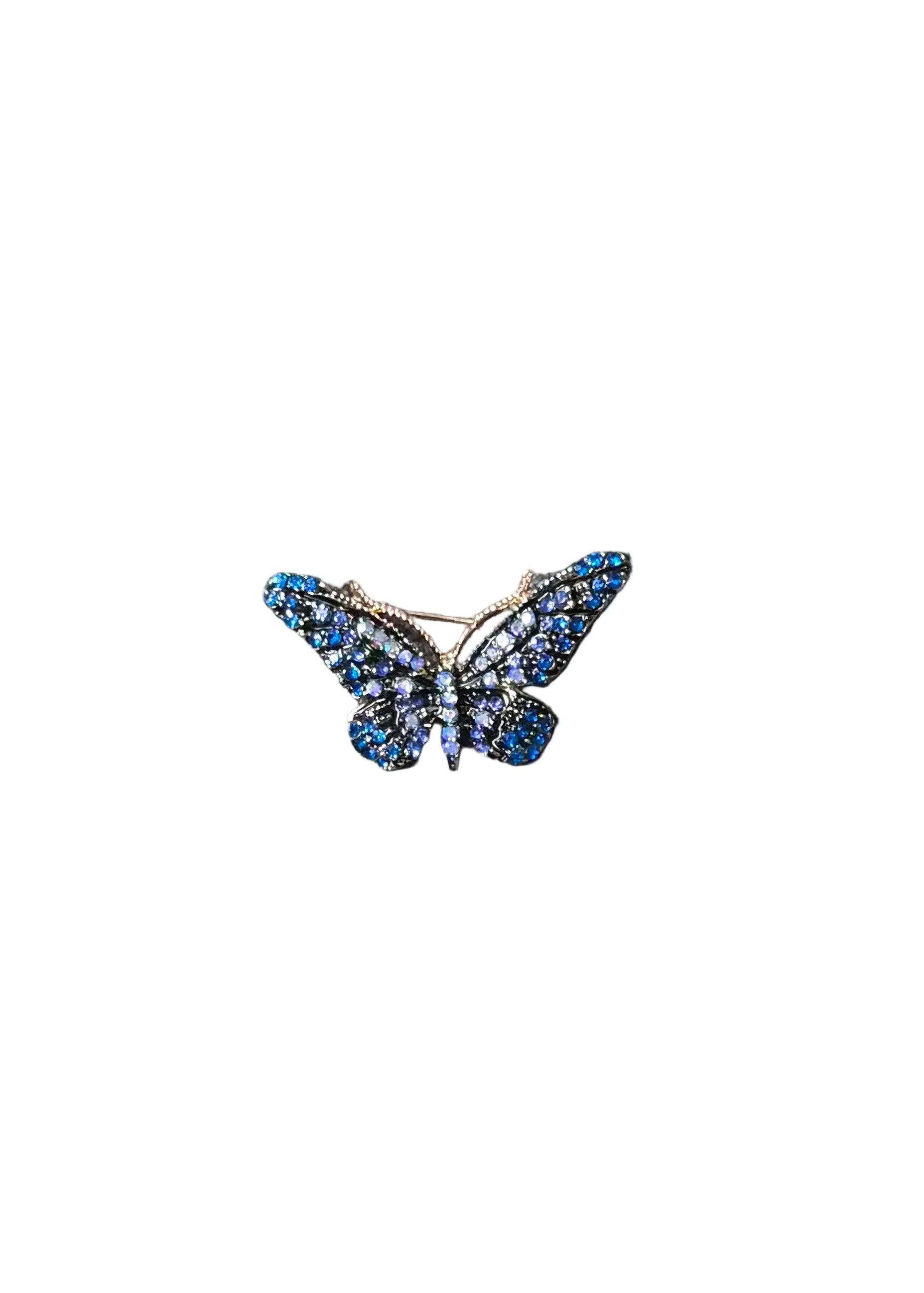 A butterfly-shaped brooch with blue crystals and silver-toned metal settings