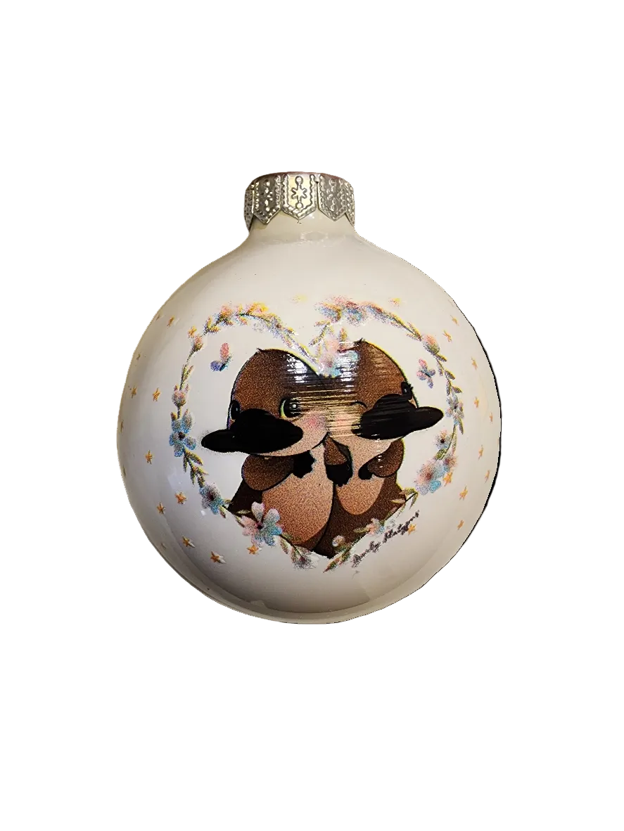 white bauble with platypus pair in heart with 'so cute' on reverse